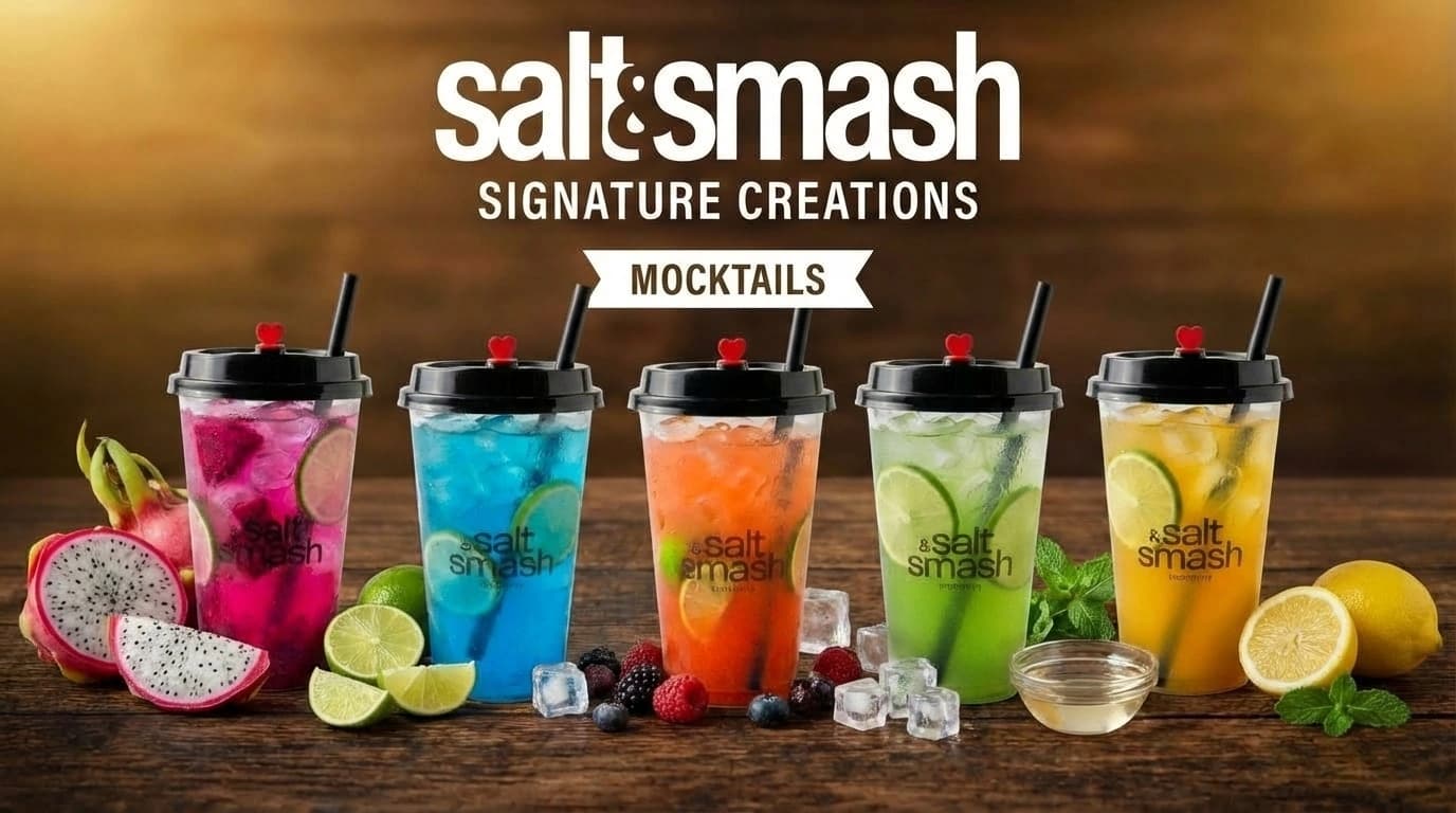 Salt & Smash Mocktails – Assorted chilled non-alcoholic beverages with fresh dragon fruit, lime slices, berries, and mint garnishes on a wooden table